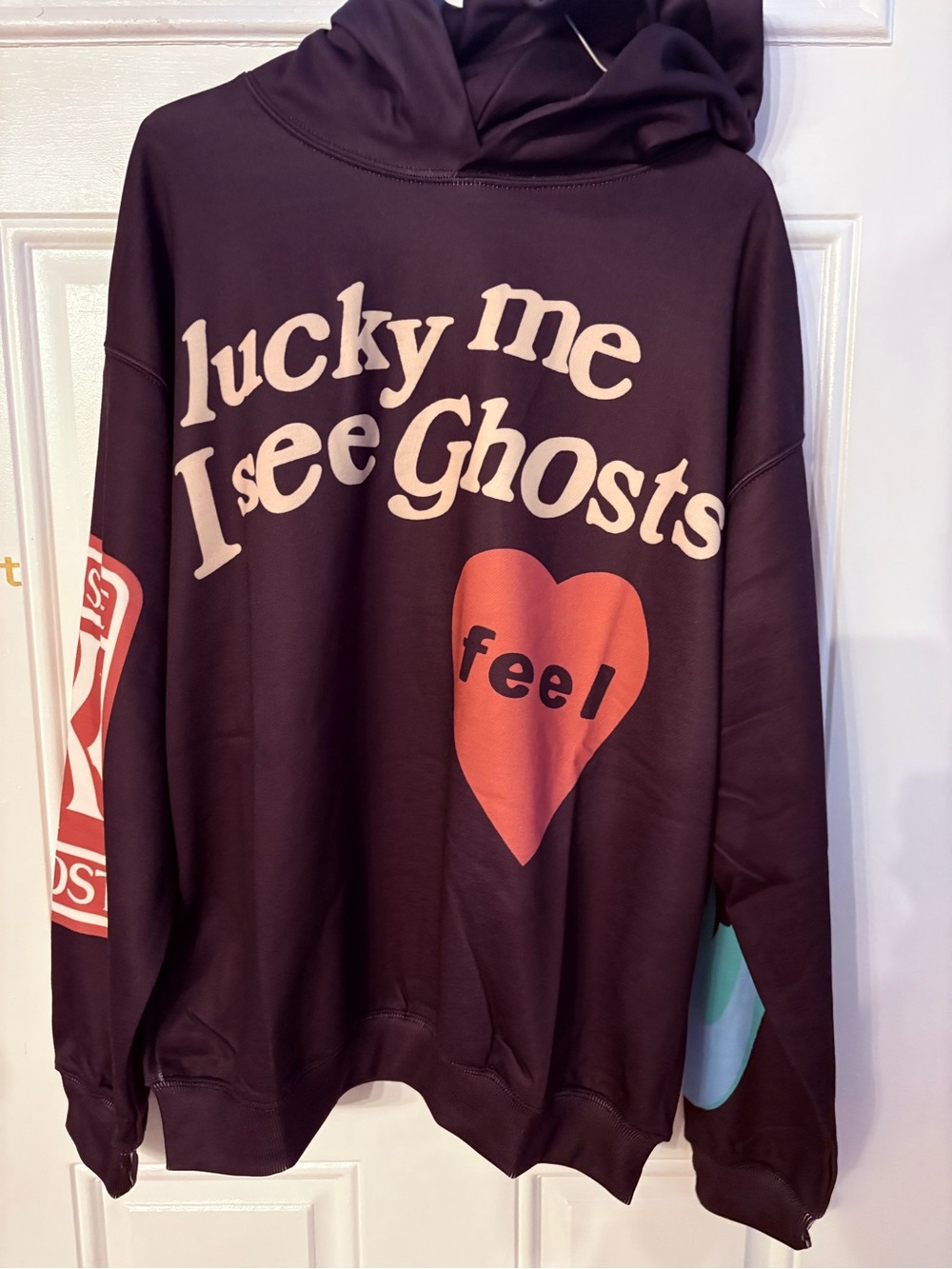 "Lucky Me I See Ghosts" hoodie with a red heart graphic, Kanye West and kid cudi